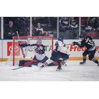 Wenatchee Wild's Evan Friesen battles Tri-City Americans' Lukas Matecha and Maxmilian Curran