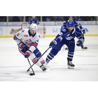 Syracuse Crunch forward Joel Teasdale (right) pokes at the puck vs. the Rochester Americans