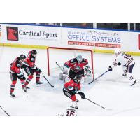 Kelowna Rockets' Michael Cicek, Eli Barrett, Jake Pilon, and Landon Cowper versus Kamloops Blazers' Tommy Lafrenière and Andrew Thomson